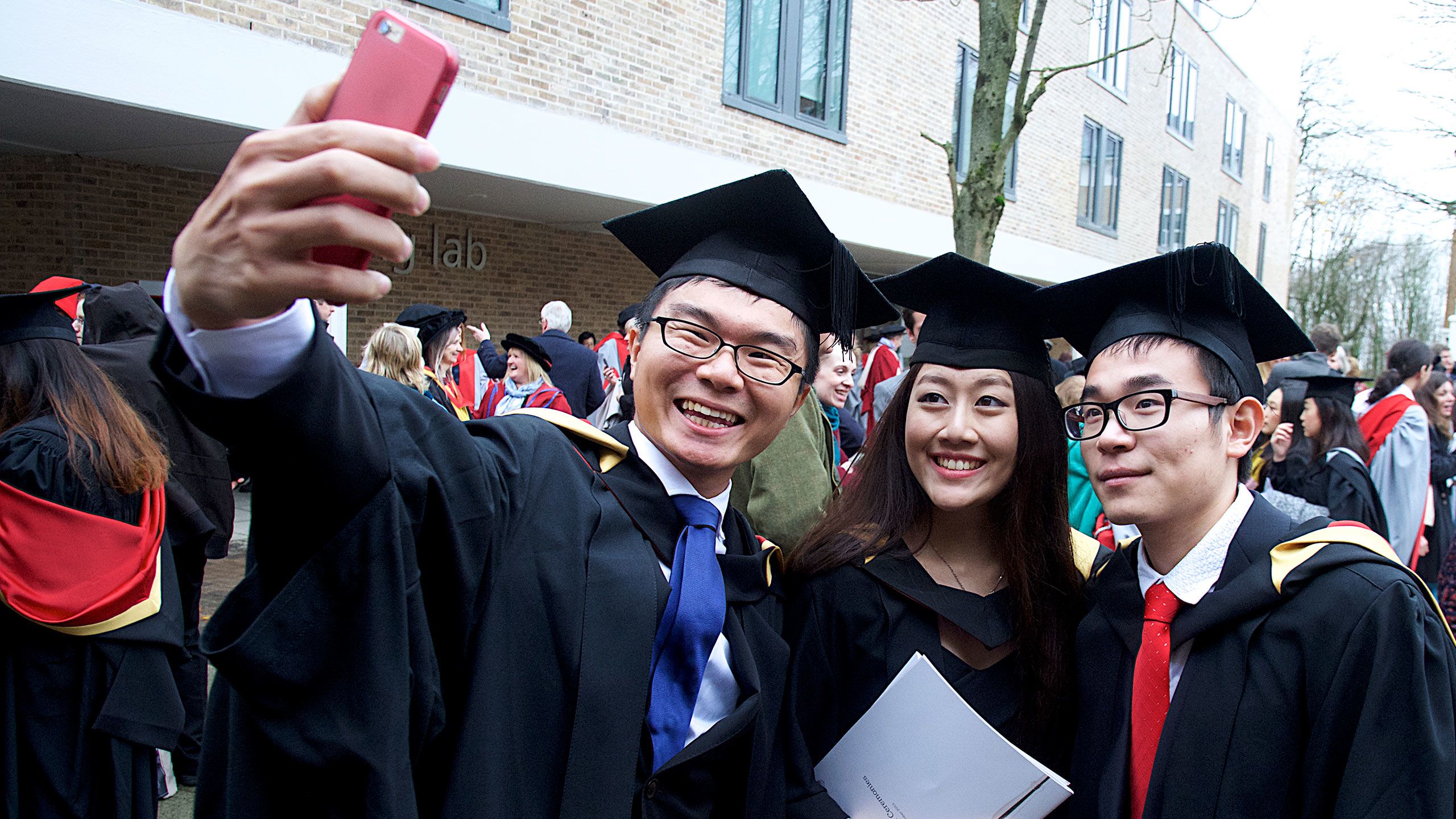 A group of graduating students taking a selfie